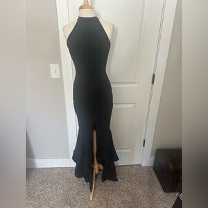 Fabulous Black Halter Neck mermaid evening gown with slit and ruffles. Bodycon